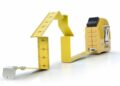 Yellow tape measure folded into a house shape on a white background illustrating measurement-driven growth to Unlock Your Website’s Potential with Continuous Improvement Strategies.