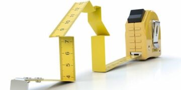 Unlock Your Website's Potential with Continuous Improvement Strategies 10 Yellow tape measure folded into a house shape on a white background illustrating measurement-driven growth to Unlock Your Website’s Potential with Continuous Improvement Strategies.