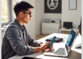Person at a desk using a smartphone and laptop while following a Step-by-Step Guide to Implementing WordPress Two-Factor Authentication.