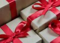 Stacked kraft gift boxes tied with red ribbons visually representing Unlock the Secrets: Affordable Monthly Website Maintenance Packages.