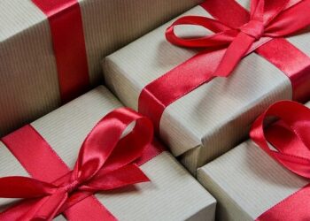 Stacked kraft gift boxes tied with red ribbons visually representing Unlock the Secrets: Affordable Monthly Website Maintenance Packages.
