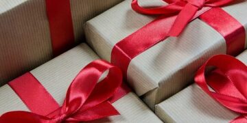 Unlock the Secrets: Affordable Monthly Website Maintenance Packages 10 Stacked kraft gift boxes tied with red ribbons visually representing Unlock the Secrets: Affordable Monthly Website Maintenance Packages.
