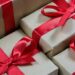 Stacked kraft gift boxes tied with red ribbons visually representing Unlock the Secrets: Affordable Monthly Website Maintenance Packages.