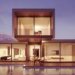 Contemporary two-story glass house at twilight with pool reflections, illustrating stability to Unlock Your Website’s Potential with Regular Maintenance