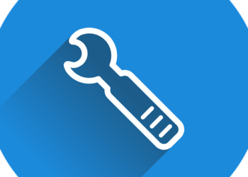 A blue circular icon with a white wrench and long shadow symbolizing site maintenance to Unlock 7 Essential Benefits of Regular Website Maintenance Today.