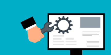 Master These 5 Steps for Flawless Website Maintenance Today! Illustration of a hand holding a wrench adjusting a gear on a desktop monitor with a teal background.