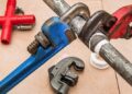Close-up of pipe wrenches, tubing cutter, and thread tape illustrating Essential Website Maintenance Reporting Tools You Can’t Ignore