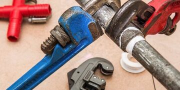 Close-up of pipe wrenches, tubing cutter, and thread tape illustrating Essential Website Maintenance Reporting Tools You Can’t Ignore