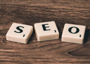 Three Scrabble-style tiles spelling SEO on a wooden surface illustrating Unlock Lightning-Fast Website Performance: 10 Must-Know Tips