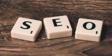 Three Scrabble-style tiles spelling SEO on a wooden surface illustrating Unlock Lightning-Fast Website Performance: 10 Must-Know Tips